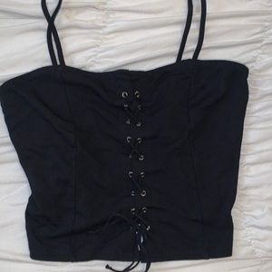 Black shirt with lazes across.